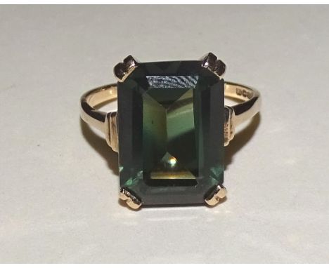 A 9ct gold dark green tourmaline ring, with large emerald cut tourmaline to centre measuring 1.4 x 1cm, stamped 375 to inside