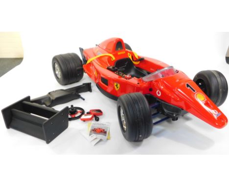 A Toys Toys ride-on electric model of a Ferrari F1 Grand Prix, Produced Under License by Fisher Price, 6.7.538.4, 142cm wide.