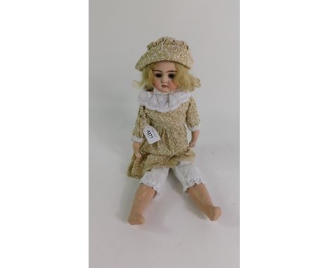 A German early 20thC bisque head doll, unmarked, modelled with brown closing eyes, open mouth, 45cm high.