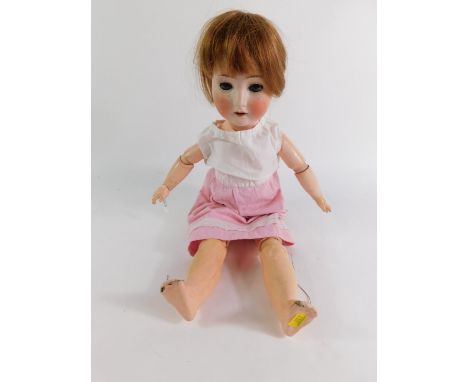 A Schoenau &amp; Hoffmeister bisque head doll, no 1909-6, 59cm high.