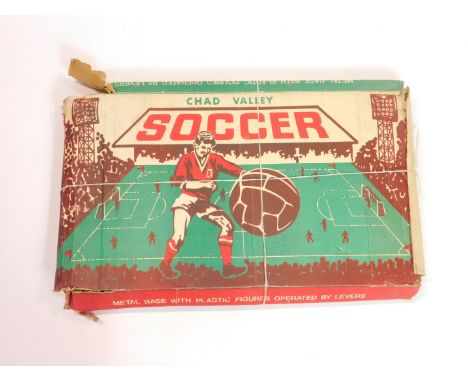 A Chad Valley Soccer game, having a metal base with plastic figures operated by levers, boxed.