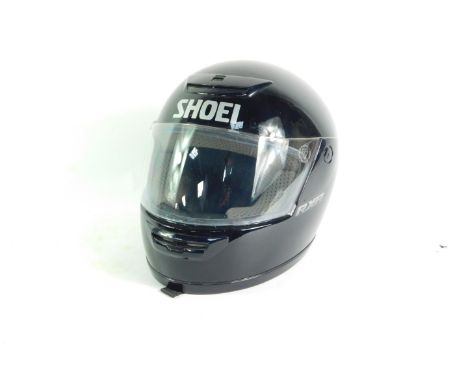 A Shoei RX-R black motorcycle helmet. 