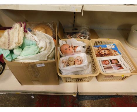 Early 20thC bisque dolls heads, limbs, clothes and reference books on dolls. (a quantity)