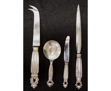 Four pieces Georg Jensen 'Acorn' silver cutlery including cheese knife; tea caddy spoon; letter opener;and butter knife.