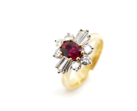 Ruby and diamond set 18ct yellow gold cluster ring marked 750. Approx 1x oval cut ruby 7mm x 4.5mm x 3mm (estimated), 6x roun