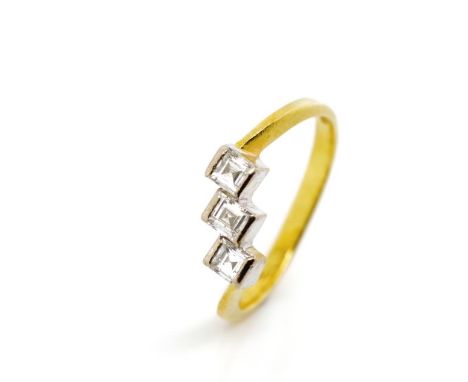 Three stone diamond and 18ct gold ring with three bezel white gold set princess cut diamonds on a mounted yellow gold shank. 