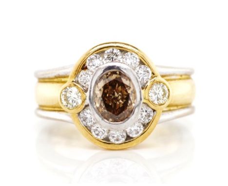 Champagne and white diamond set 18ct gold ring with a yellow gold body and white gold highlights, marked 750 and for Robert M