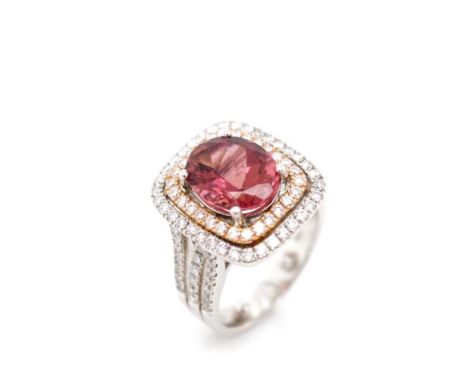 Tourmaline and diamond set 18ct gold halo ring by Hardy Bros. With a inner rose gold and outer white gold double halo setting