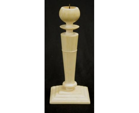 Antique Chinese carved ivory candlestick column shaped candle stick, with rectangular base, (height 18cm approx). NOTE: Expor