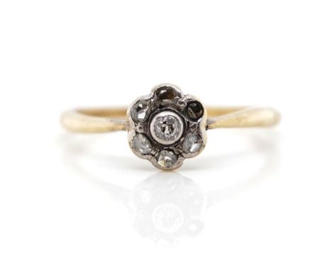Antique diamond and yellow gold daisy ring set with old cut diamonds, marked 18ct. Approx weight 1.7 grams, ring size M. A/f 