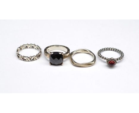 Four silver rings includes two Pandora and one Thomas Saboo piece. As well as a marked T&amp;Co piece. Approx ring size N-O