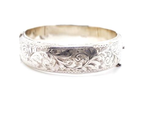George VI sterling silver bangle with hinged movement and bright cut engraved decoration, marked Chester 1949. Approx 27 gram