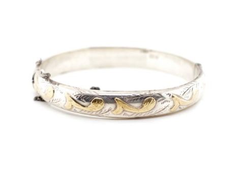 George VI sterling silver bangle with yellow gold foliate highlights. Marked JS Chester 1951. Approx weight 12 grams, inside 