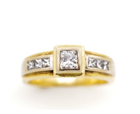 Princes cut diamond set 18ct yellow gold ring marked 750. With valuation: 7x princess cut diamonds, 6x channel set (0.25ct), 