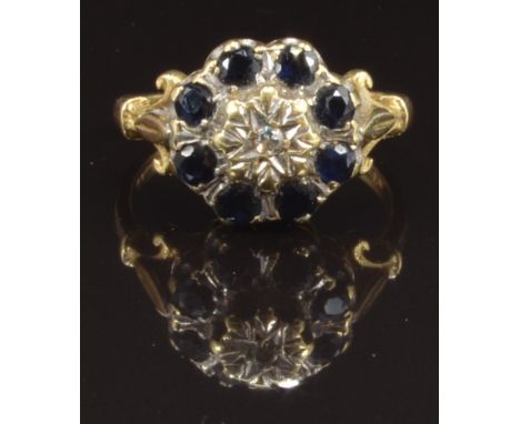 An 18ct gold ring set with a diamond surrounded by sapphires, size P, 5.1g