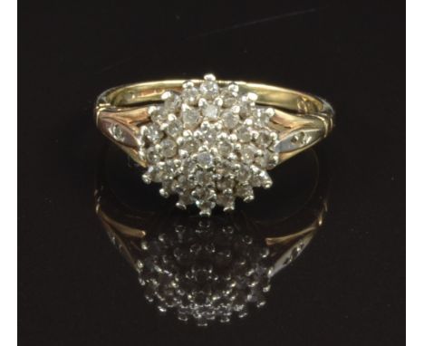 A 9ct gold ring set with diamonds in a cluster, size K, 2.3g