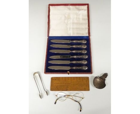 Cased set of hallmarked silver handled knives together with a pair of hallmarked silver sugar tongs, weight 21g, rule, pair o