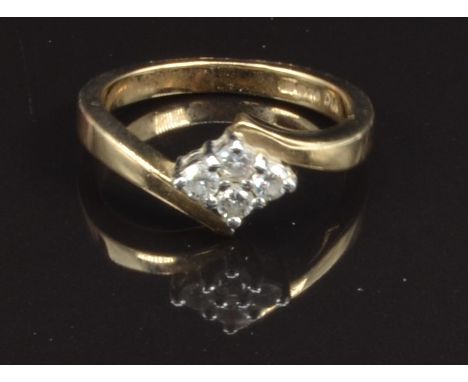 A 9ct gold ring set with four diamonds, size K, 3g