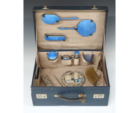 Blue leather travelling vanity case with fitted interior and blue guilloché enamel mounted bottles, brushes and mirror, hallm