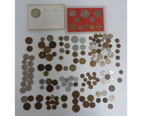 Maria Theresa silver coin and further world coinage, in a vintage tin&nbsp;