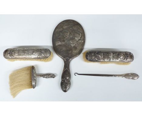 Three piece hallmarked silver dressing table set with decoration of Reynold's Angels, comprising hand mirror and two brushes,