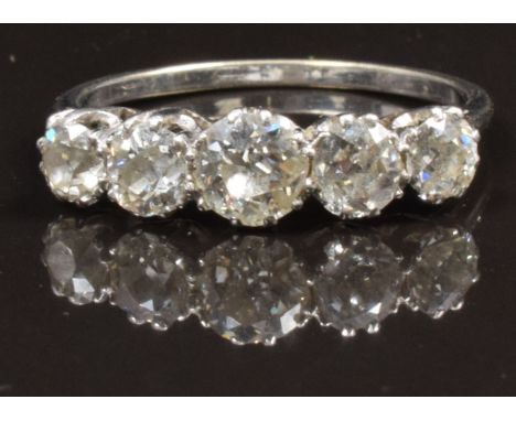 An 18ct white gold ring set with five old cut diamonds, the centre stone approximately 0.5ct, in Goldsmiths &amp; Silversmith