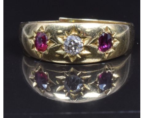 An 18ct gold ring set with a diamond and rubies, 2.5g