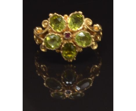 A 9ct gold ring set with a ruby surrounded by peridot in a flower cluster, size N, 4.1g