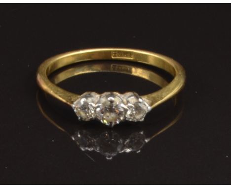 An 18ct gold ring set with three diamonds, size K, 2g
