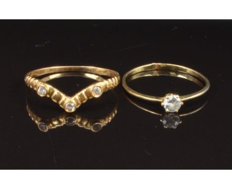 Two yellow metal rings set with paste, sizes R &amp; U, 2.7g