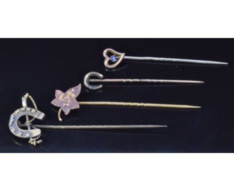 Victorian silver stick pin in the form of a horseshoe and riding crop, a 9ct gold stick pin set with a sapphire and two other