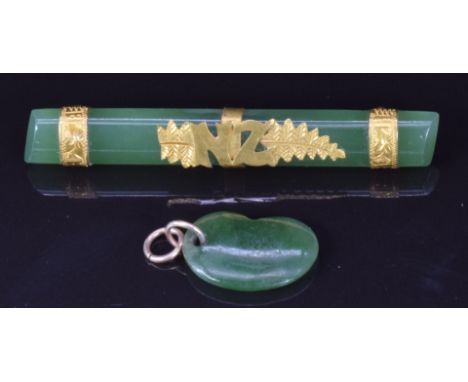 A 9ct gold and jade brooch with NZ for New Zealand and a jadeite kidney bean charm/ pendant&nbsp;