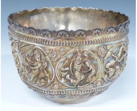 Indian or Burmese white metal bowl with embossed decoration of deities including playing instruments and in a boat, diameter 