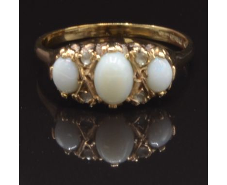 A 9ct gold ring set with opals and paste, size T, 3.3g