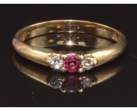 A 9ct gold ring set with a round cut ruby and two round cut diamonds, size N, 2.3g