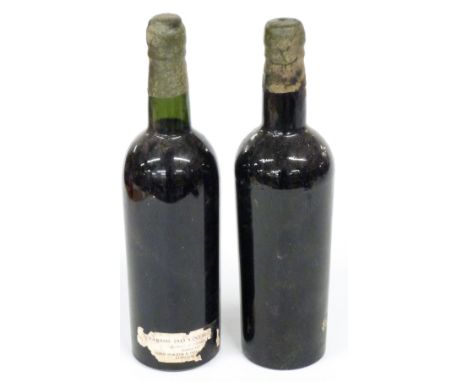 Two bottles Barros 1945 vintage port, bottled by John Porter and Gold... London, label part missing from one bottle, the othe