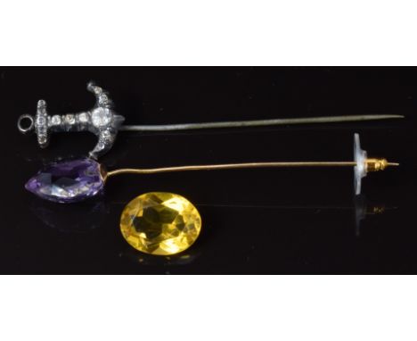 Victorian stick pin set with paste in the form of an anchor and a yellow metal stick pin set with amethyst&nbsp;