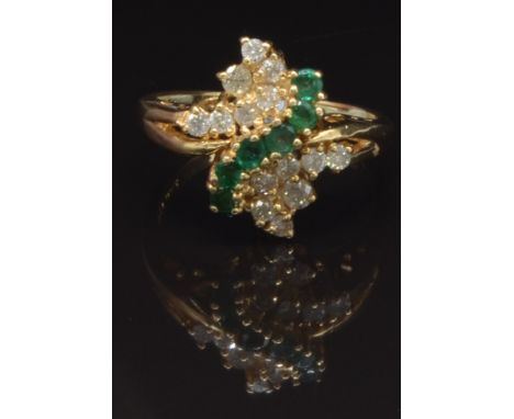 A 14k gold ring set with round cut emeralds and diamonds, size Q, 5g