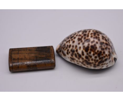 An antique wood snuff box; together with another cowrie shell example. 