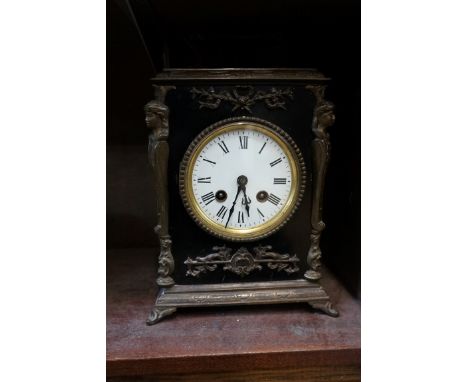 An antique ebonized and brass mounted mantel clock,&nbsp;striking on a bell, 26cm high, with key. 