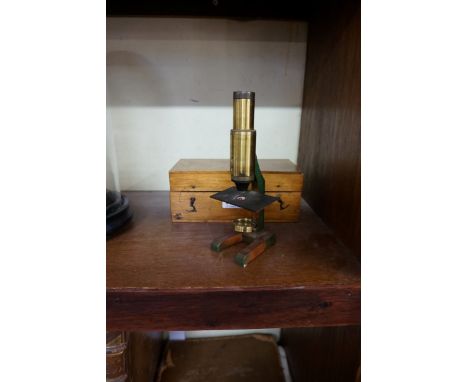A small lacquered brass field microscope,&nbsp;in box.&nbsp; 