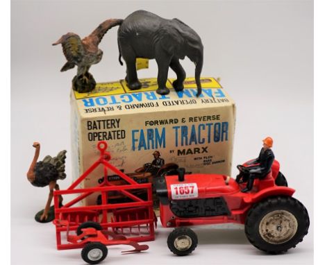 A Marx battery operated farm tractor, boxed; together with three Elastolin animals.&nbsp; 