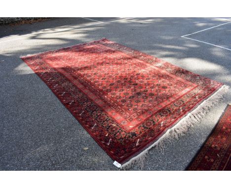 A large carpet, having repeated decoration to central field, with floral and geometric borders, 334 x 220cm. 