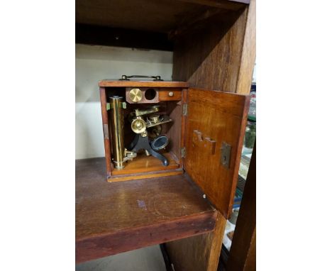 A brass monocular microscope, in mahogany case.&nbsp; 
