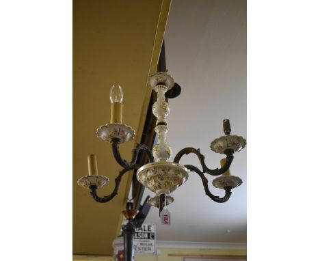 A brass and ceramic five branch ceiling light. 