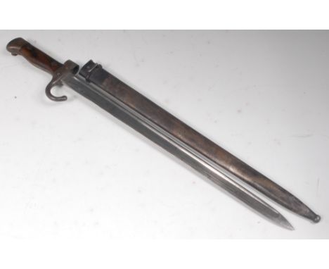 A French model 1892 bayonet, the 42cm single edged fullered blade stamped to the ricasso J.C, the hooked quillon numbered 65?
