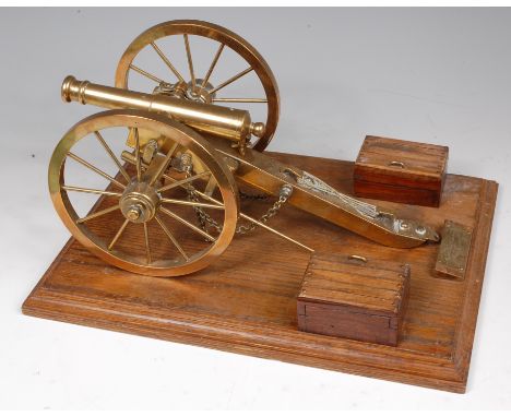 A precision built brass scale model of a Napoleonic Field Gun, on an oak plinth base, h. 18cm.