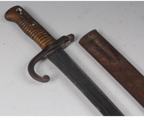 A French model 1866 Chassepot bayonet, having a 56.5cm yataghan shaped single edged blade, hooked quillon and ribbed brass gr