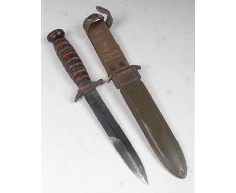 A U.S. Army M3 trench knife, the 17cm double edged blade stamped U.S. M3 CAMILLUS, having a leather ringed grip and stamped t