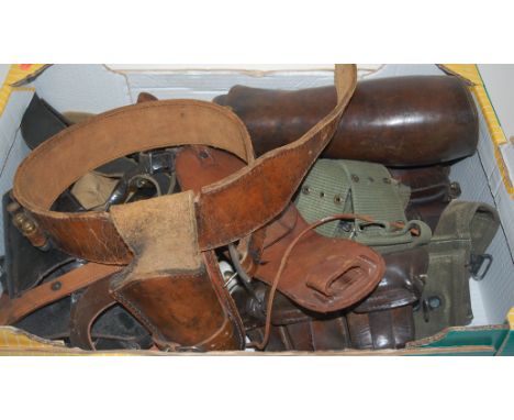 A collection of assorted WW I and later military items to include a leather bayonet frog, pair of leather gaiters, Colt 45 gu